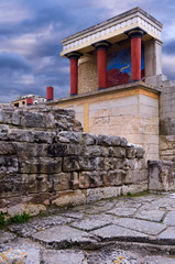 Knossos Palace, Heraklion - Crete. The north entrance of the minoan palace with the charging bull fresco. Knossos is the largest Bronze Age archaeological site on Crete. Cloudy sky