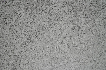 Gray plastered wall in sunlight. Modern building materials for e