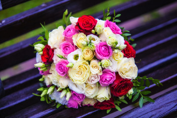beautiful wedding bouquet lies on the bench