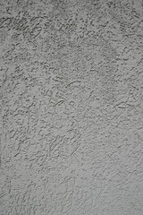 Gray plastered wall in sunlight. Modern building materials for e