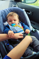 boy in the child seat and his mother, safe driving protocol.