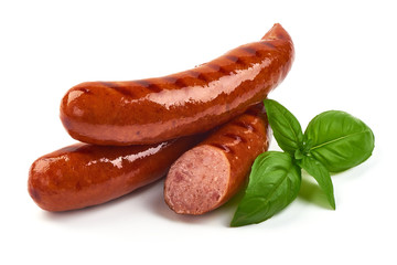 German grilled pork sausages with basil leaves, close-up, isolated on white background