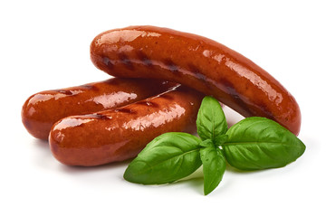 German grilled pork sausages with basil leaves, close-up, isolated on white background