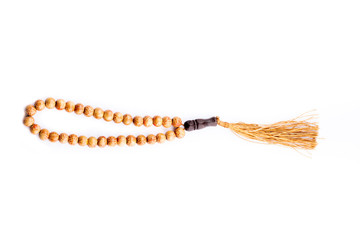 tasseled rosary on white background