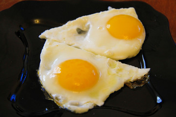 Roasted eggs on the black plate