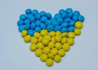 heart made of colorful candies isolated on white