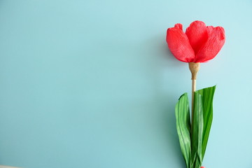 Red Paper Flower isolated on a Light Blue Background