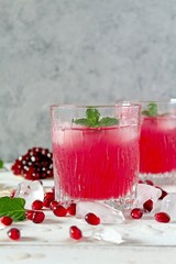 Ripe pomegranate with juice on light background. Top view with copy space.