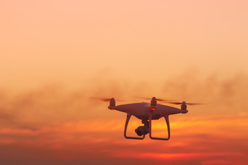 flying drone on the background of a beautiful sunset / beautiful sky drone doing its job