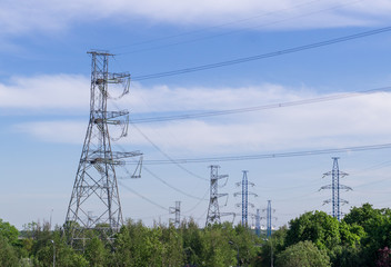 power transmission line at summer in the city. industrial, nature.