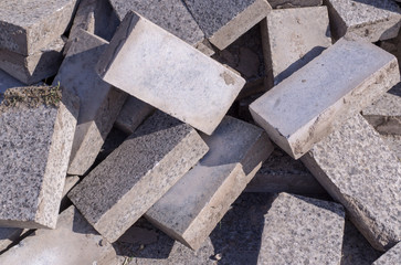 Pile of dirty gray curb bricks. background, texture.