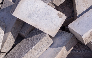 Pile of dirty gray curb bricks. background, texture.