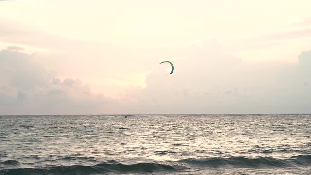 Parasailing tropical beach evening view, of the plane is down near the airport. tropical white sand beach. Sea waves seamless loop on the beautiful sand beach,Phuket Thailand.