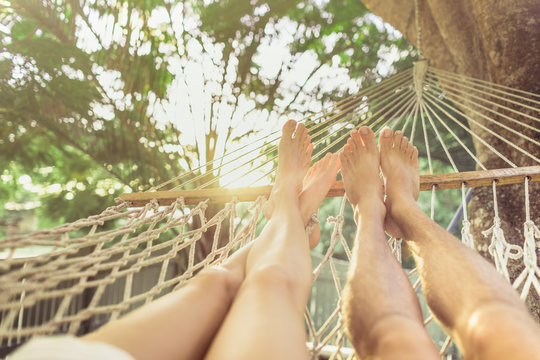 man and woman relaxing in hammock
