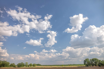 blue sky with clouds over summer field