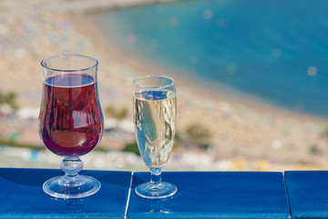 Two glasses of wine on the balcony of the luxurious hotel, illustrating wonderful vacations.