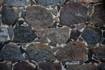 Wall of grey and brown stones. Abstract texture