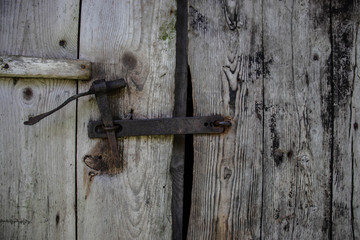 Metal rusty bolt on an old wooden door