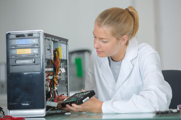 young adult female working on assembling circuit components