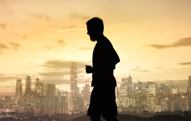 Fototapeta premium Silhouette of man running in the city