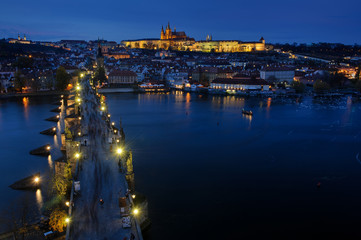 Fototapeta na wymiar Tourists at Prague Charles Bridge at night. Prague cityscape of historical center