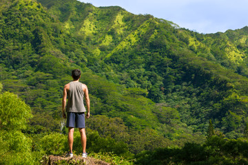 Fit male hiker reaching the top of a mountain. 