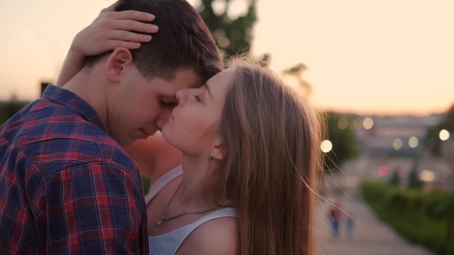 Sweet talking. Couple communication. Teenage loving relationship. Young man and woman chatting in the street and kiss.