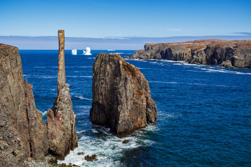 Fototapeta na wymiar An iceberg along the Newfoundland coastline in summer, very popular with tourist.