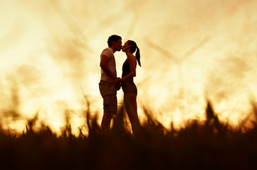 Fototapeta premium Couple kissing at sunset, people love and relationships 