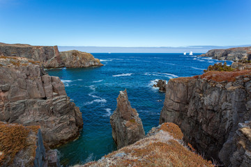 Fototapeta na wymiar An iceberg along the Newfoundland coastline in summer, very popular with tourist.