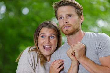 Fototapeta premium scared young couple in safari suits in jungle