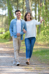 Obraz premium couple on casual attire walking on path