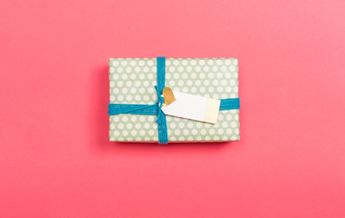 A gift box on a pink paper background