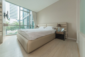 Open spacious bedroom with modern stylish furniture.