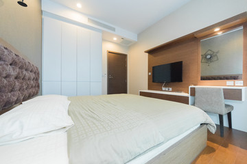 Open spacious bedroom with modern stylish furniture.