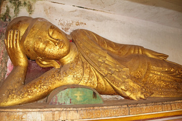 Old golden Buddha statue at Pho Win Taung Caves, Monywa city, Sagaing State, Myanmar, Asia.