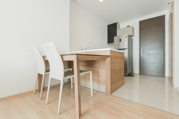 Naklejka na ściany i meble Stylish kitchen interior with dining table and chairs