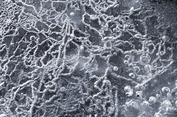 Texture abstract closeup background ice with grooves, furrows, and bubbles of air cought by frost...