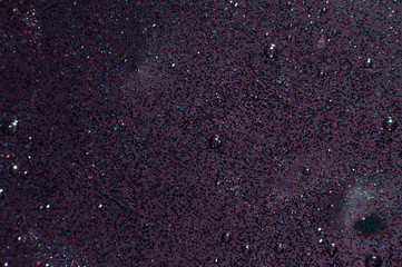 Abstract background dark slime with glittering multicolor particles