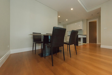 Wooden chairs at table in bright open space interior 
