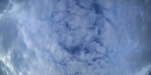Stitched wide angle shot of altocumulus floccatus clouds
