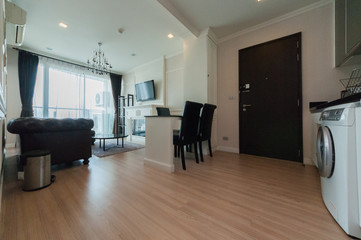 Wooden chairs at table in bright open space interior 