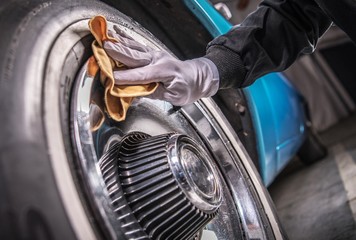 Men Cleaning Car Wheels