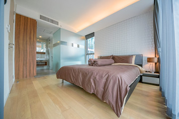 Luxury bedroom interior with large comfortable bed. Space for text 
