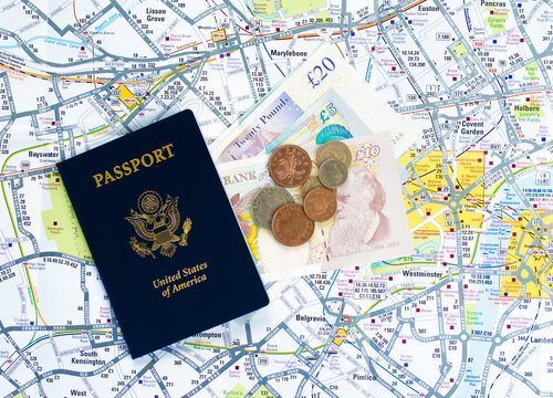 American passport with British paper currency and coins on a map of London