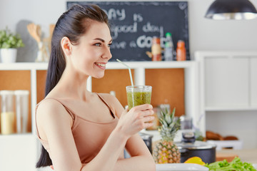 a young girl drinks a cocktail on a kitchen