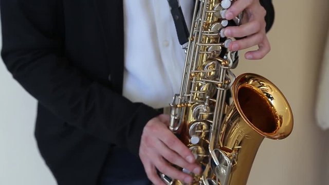 Close up of male's hands playing the saxophone HD