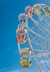 Colourful Ferris Wheel in the amusement park. Ferris Wheel with blue background. Funfair. .