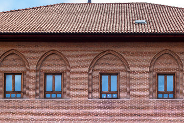 Front shoot of brick masonry structured old house under bright sky