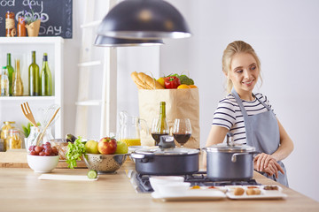 Young Woman Cooking in the kitchen. Healthy Food